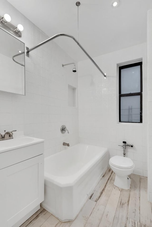 3000 Valentine Ave Unit 3C, New York City, NY 10458 - full bath with tile walls, bathtub / shower combination, vanity, and wood finished floors