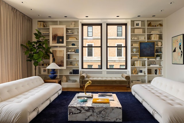 993 Park Ave Unit 11A, New York City, NY 10028 - living area featuring dark wood finished floors and built in shelves