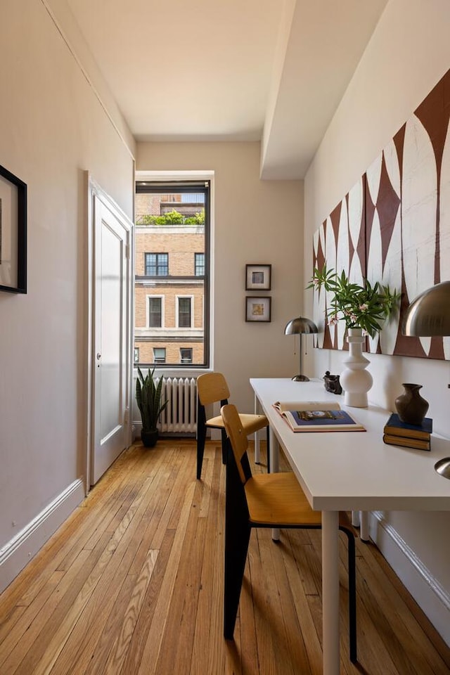 993 Park Ave Unit 11A, New York City, NY 10028 - dining room featuring radiator and light wood-style flooring