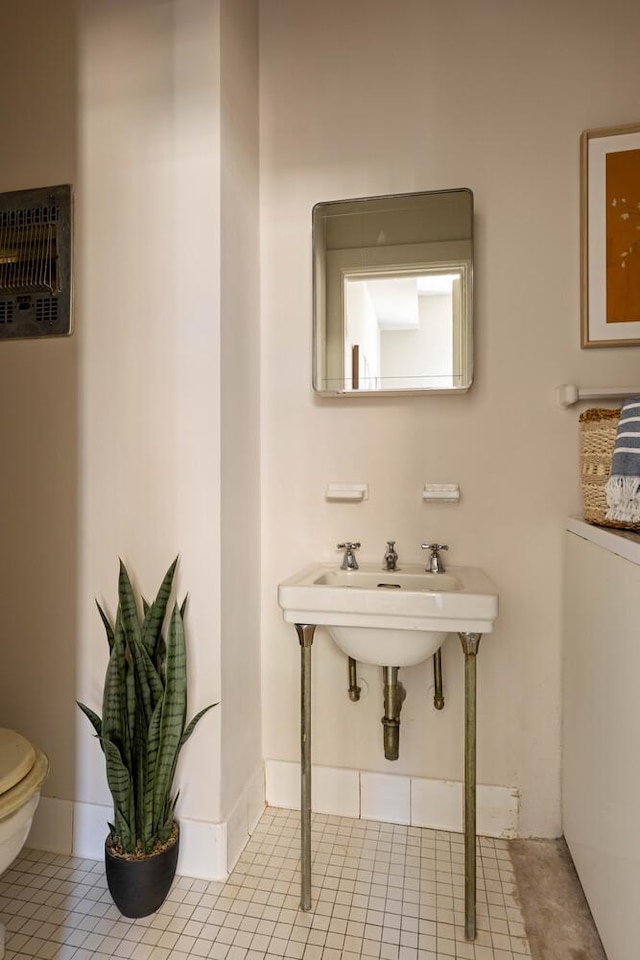 993 Park Ave Unit 11A, New York City, NY 10028 - bathroom with toilet and tile patterned flooring