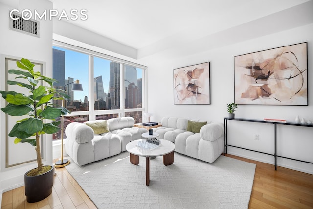 350 W 42nd St Unit 27K, New York City, NY 10036 - living room with wood finished floors and a skyline view