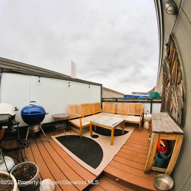 wooden terrace featuring outdoor lounge area and grilling area