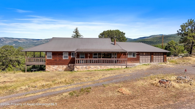 ranch-style house featuring a mountain view and a porch