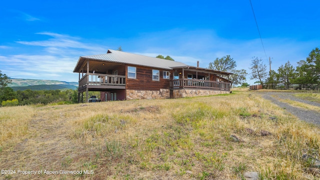 back of property with a mountain view