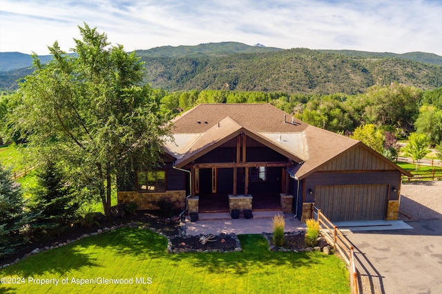 313 Cerise Ranch Rd, Carbondale, CO 81623 - view of front of property featuring a mountain view, stone siding, driveway, and a garage