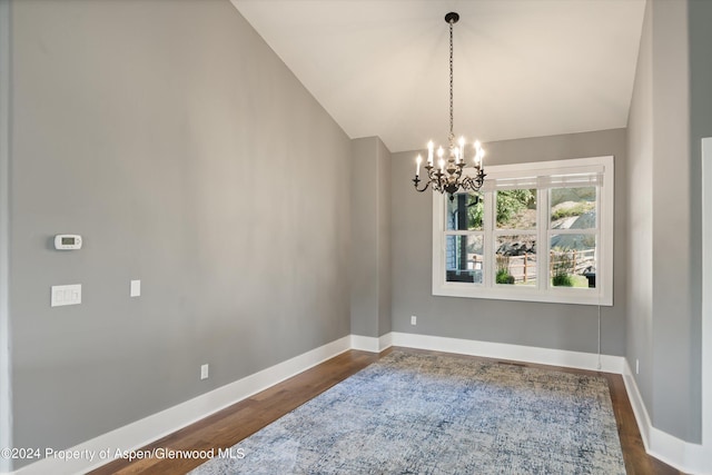 313 Cerise Ranch Rd, Carbondale, CO 81623 - empty room featuring dark wood-type flooring, vaulted ceiling, baseboards, and a chandelier