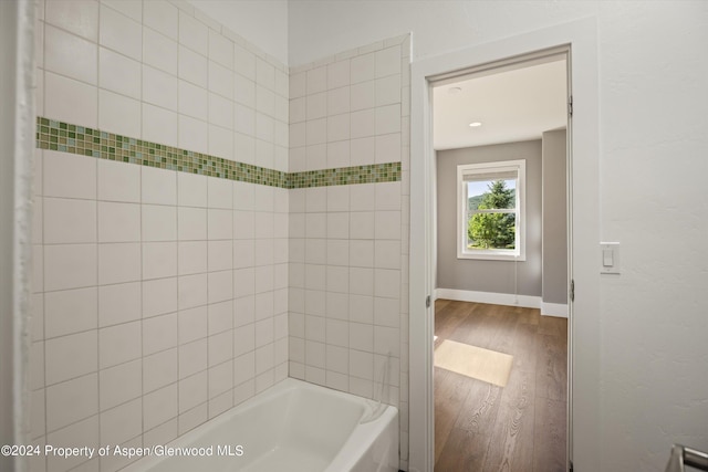 313 Cerise Ranch Rd, Carbondale, CO 81623 - bathroom featuring wood finished floors, baseboards, and bathing tub / shower combination