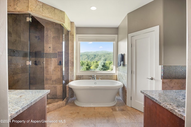 313 Cerise Ranch Rd, Carbondale, CO 81623 - bathroom with vanity, a soaking tub, a stall shower, tile walls, and a wainscoted wall