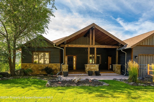 313 Cerise Ranch Rd, Carbondale, CO 81623 - back of property featuring a yard, a porch, and stone siding