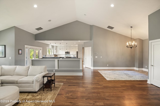 313 Cerise Ranch Rd, Carbondale, CO 81623 - living room featuring high vaulted ceiling, a chandelier, dark wood-style flooring, and baseboards