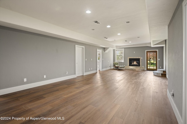 313 Cerise Ranch Rd, Carbondale, CO 81623 - unfurnished living room featuring wood finished floors, recessed lighting, baseboards, and a glass covered fireplace