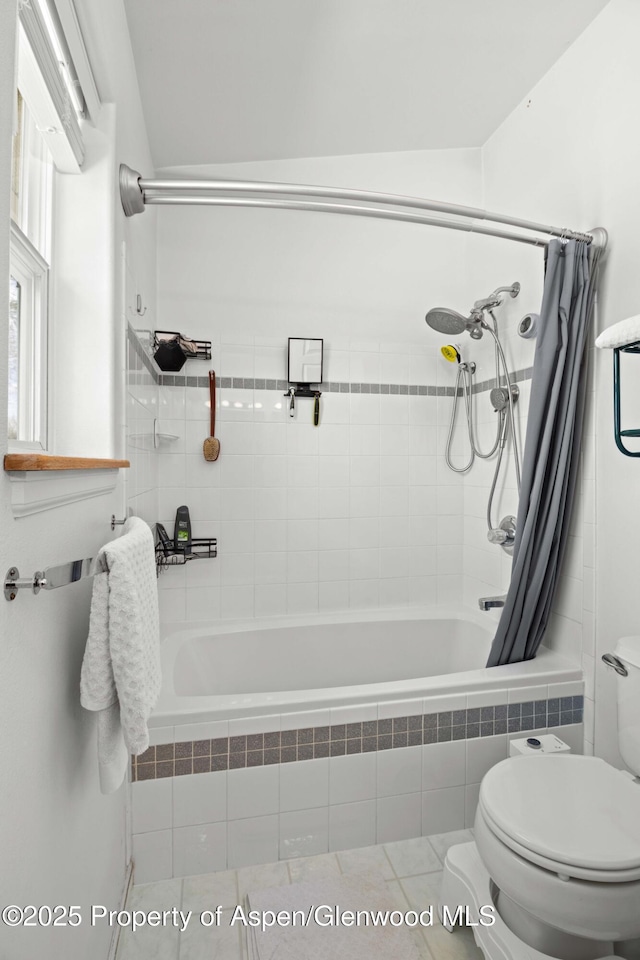 full bathroom featuring tiled shower / bath and toilet