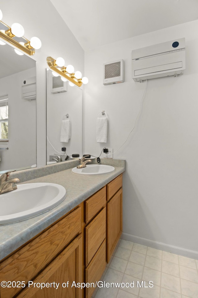 full bathroom with double vanity, a sink, an AC wall unit, and baseboards