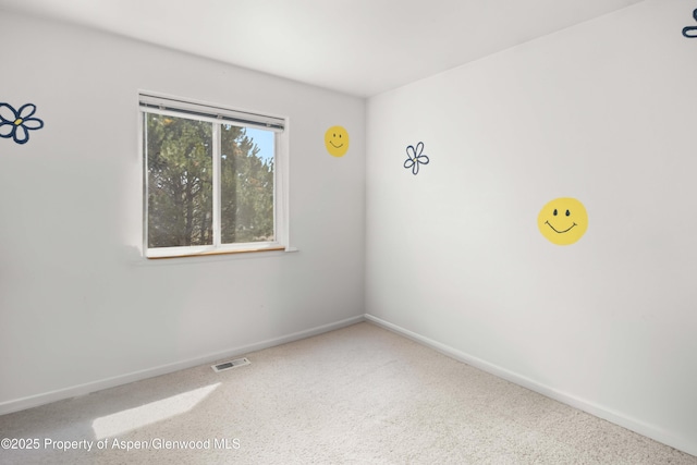 carpeted empty room with baseboards and visible vents