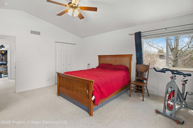 carpeted bedroom with baseboards, a closet, vaulted ceiling, a ceiling fan, and visible vents