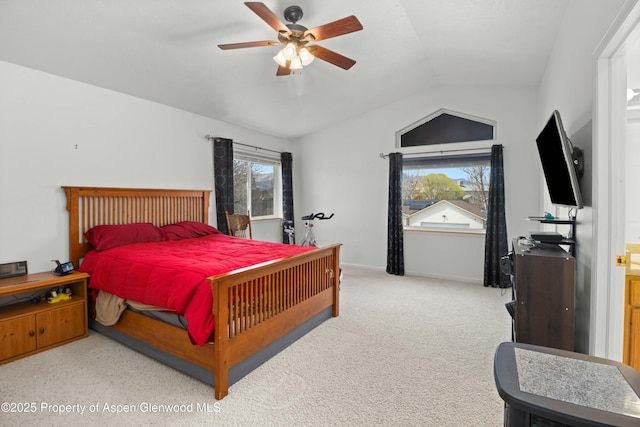 carpeted bedroom featuring baseboards, a ceiling fan, and vaulted ceiling