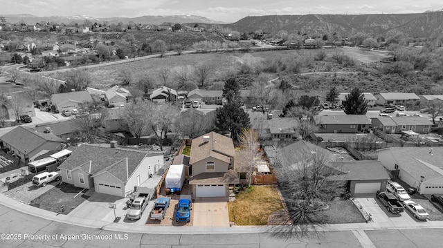 drone / aerial view featuring a residential view and a mountain view