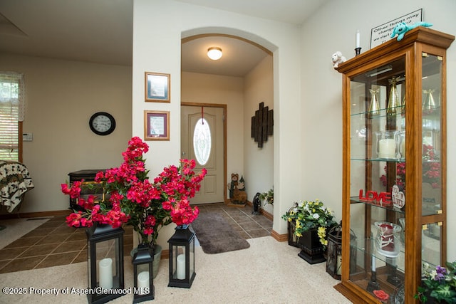 14651 County Road 3, Craig, CO 81625 - tiled dining room featuring arched walkways, plenty of natural light, and baseboards