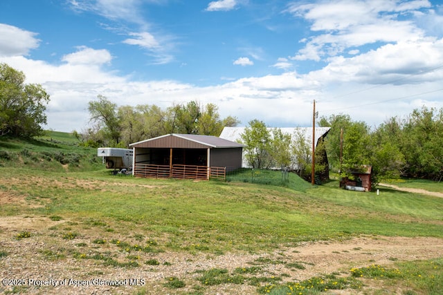 14651 County Road 3, Craig, CO 81625 - view of green lawn featuring a pole building and an outbuilding