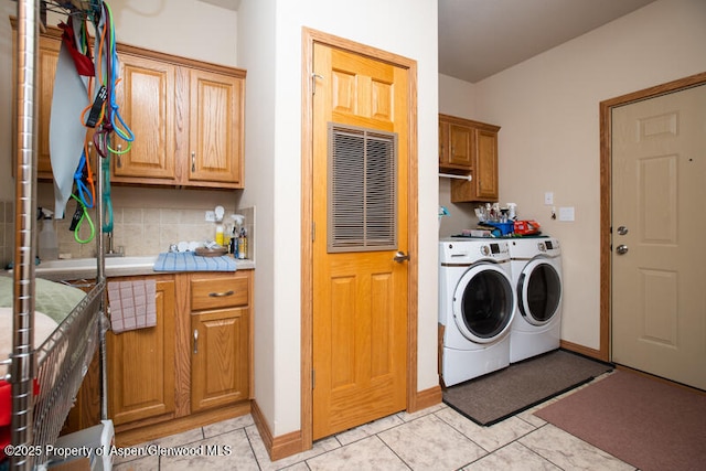 14651 County Road 3, Craig, CO 81625 - washroom with cabinet space, separate washer and dryer, light tile patterned floors, and baseboards