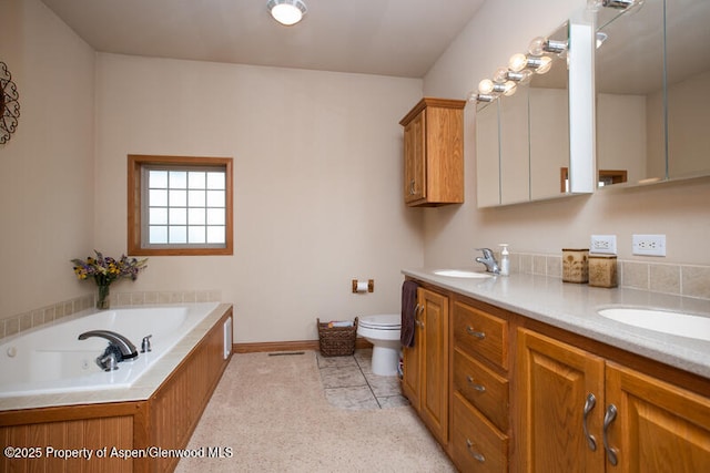 14651 County Road 3, Craig, CO 81625 - full bathroom featuring double vanity, toilet, a garden tub, and baseboards