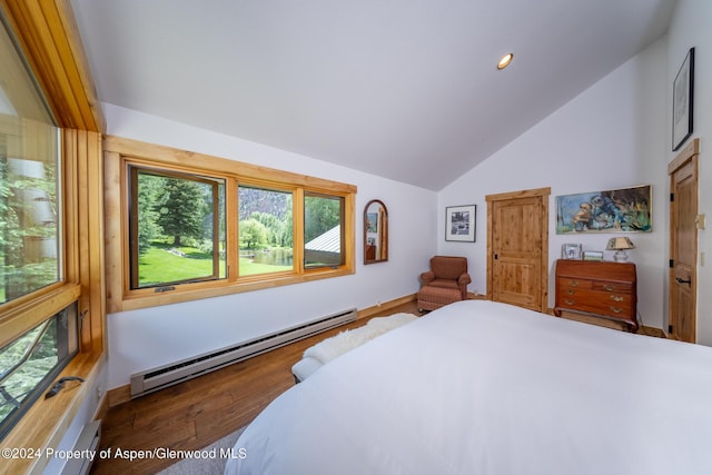 bedroom featuring a baseboard radiator, vaulted ceiling, and hardwood / wood-style flooring