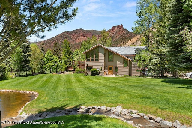 exterior space featuring a mountain view and a yard