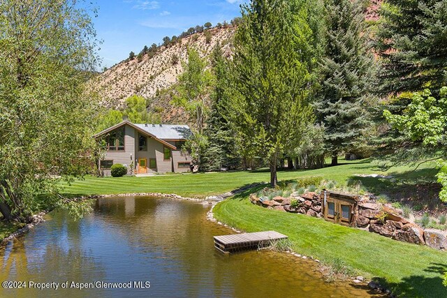 exterior space featuring a mountain view and a boat dock