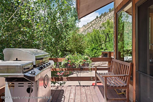 deck featuring a mountain view and a grill