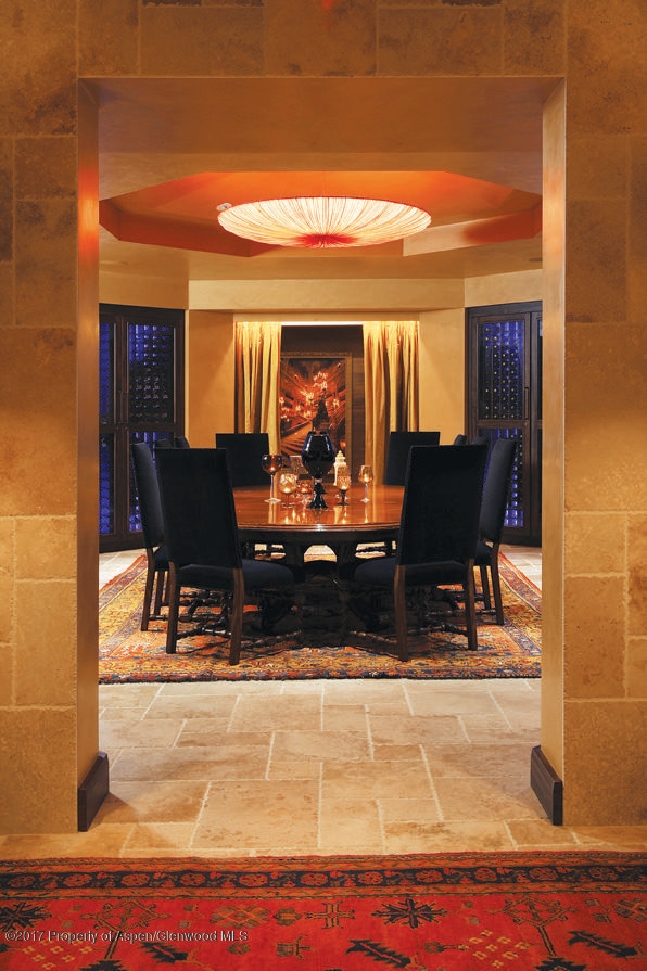 dining room featuring stone tile floors and a tray ceiling