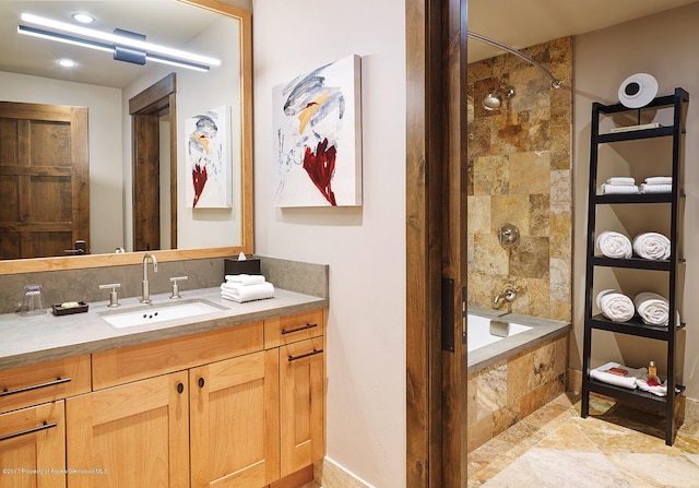 bathroom with vanity and tiled shower / bath