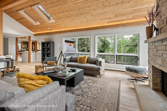 living room featuring a skylight, a large fireplace, wooden ceiling, a baseboard radiator, and light wood-type flooring