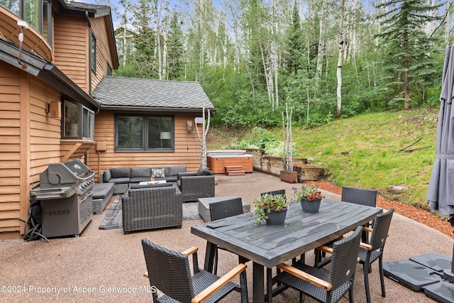 view of patio / terrace with an outdoor living space, area for grilling, and a hot tub