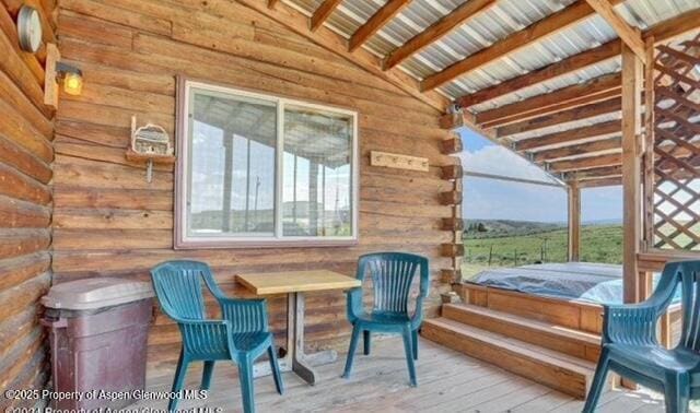 deck featuring a covered hot tub
