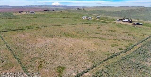 birds eye view of property with a rural view