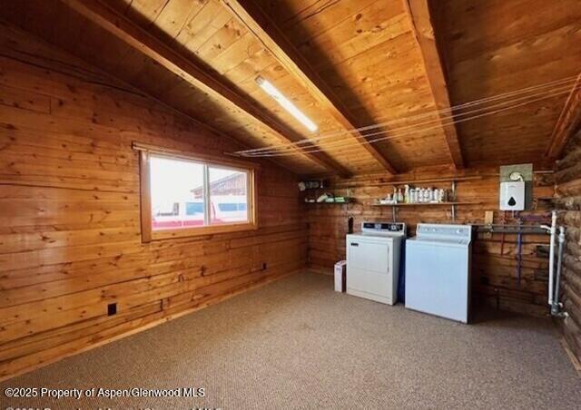 bonus room featuring carpet floors, wood walls, wood ceiling, and washer and clothes dryer