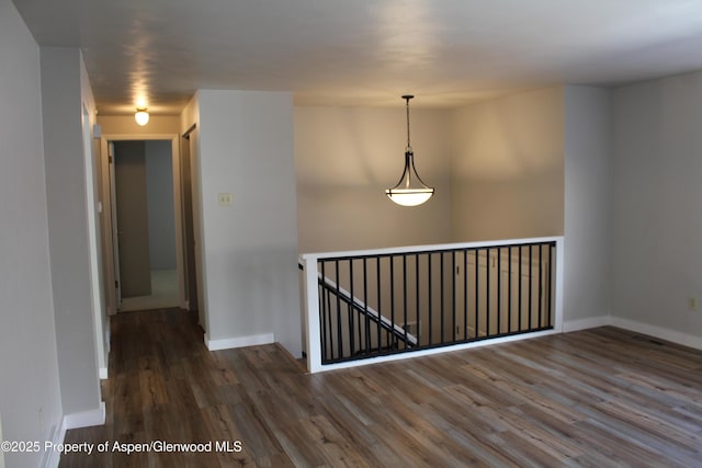 unfurnished room featuring dark hardwood / wood-style flooring