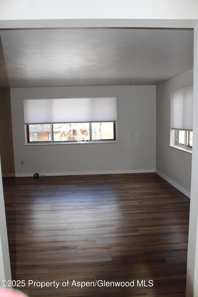 unfurnished room featuring dark hardwood / wood-style flooring