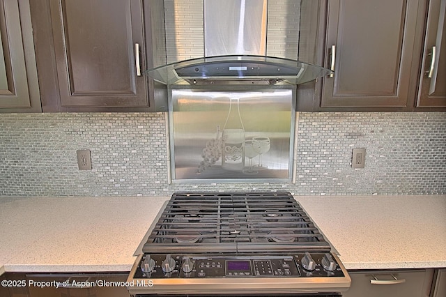 572 E Main St, New Castle, CO 81647 - kitchen featuring wall chimney range hood, stainless steel gas range, dark brown cabinetry, light countertops, and decorative backsplash