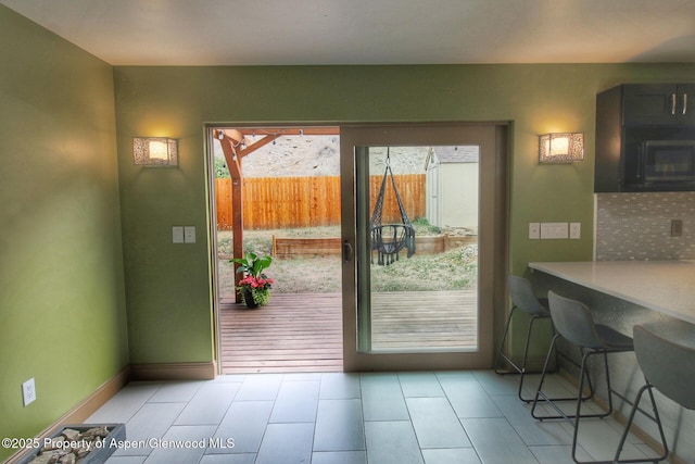 572 E Main St, New Castle, CO 81647 - doorway to outside featuring tile patterned floors and baseboards