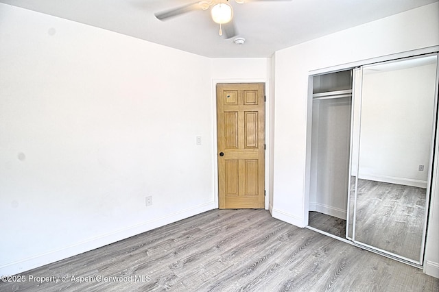 572 E Main St, New Castle, CO 81647 - unfurnished bedroom with wood finished floors, a closet, and ceiling fan