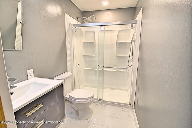 572 E Main St, New Castle, CO 81647 - bathroom featuring marble look tile flooring, a stall shower, and vanity