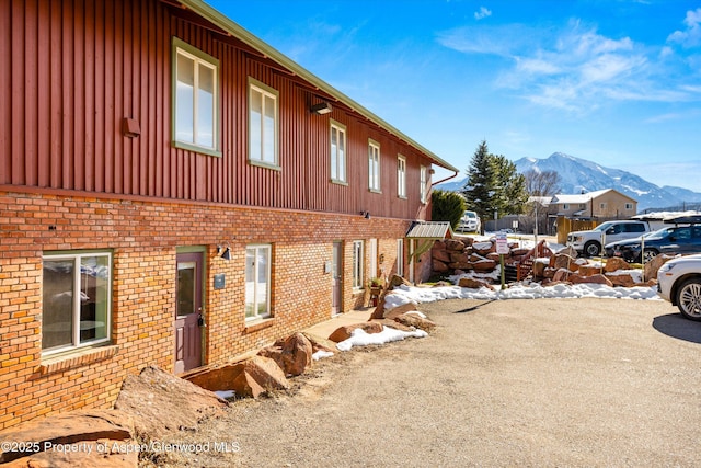 view of snowy exterior featuring a mountain view