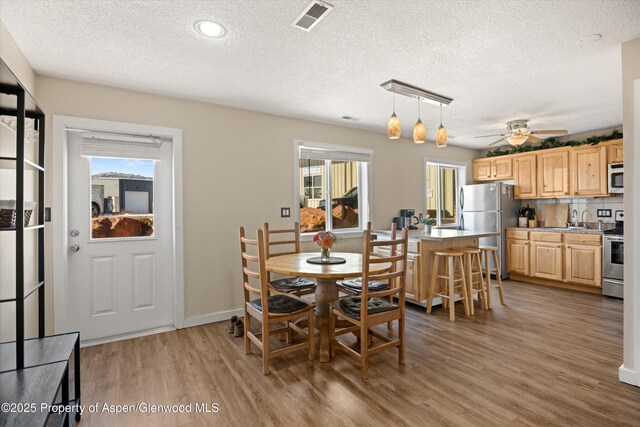 1101 Village Rd Unit Ll3B, Carbondale, CO 81623 - dining room featuring light wood-type flooring, a textured ceiling, a ceiling fan, and recessed lighting