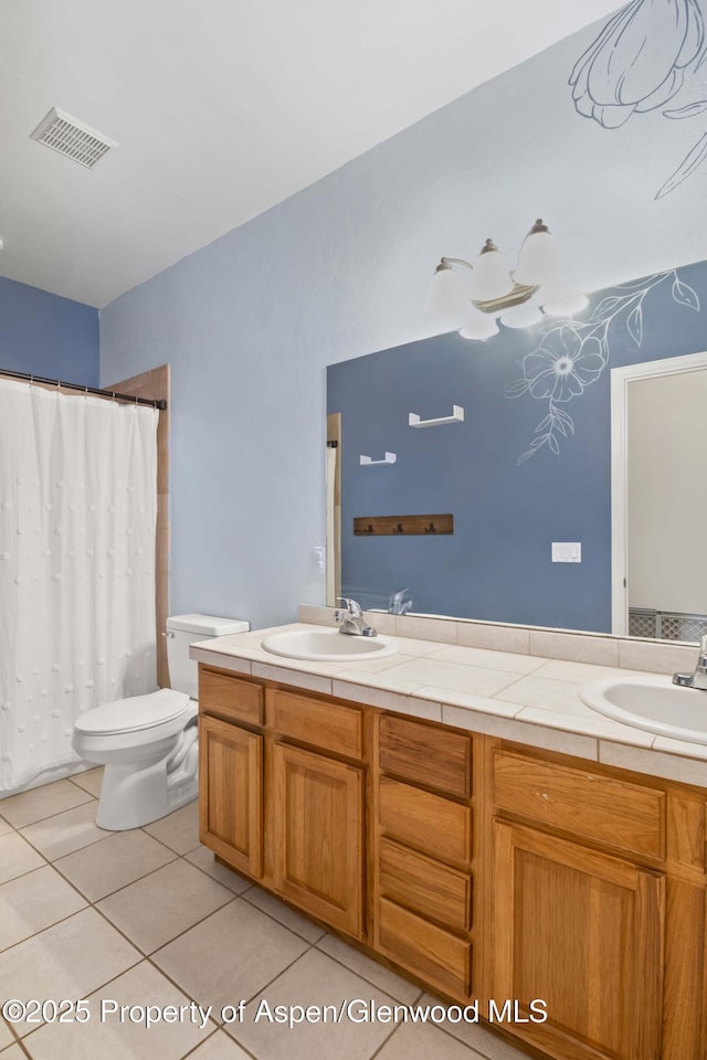 24 Lupine Ln, Parachute, CO 81635 - bathroom with tile patterned floors, toilet, double vanity, and a shower with shower curtain