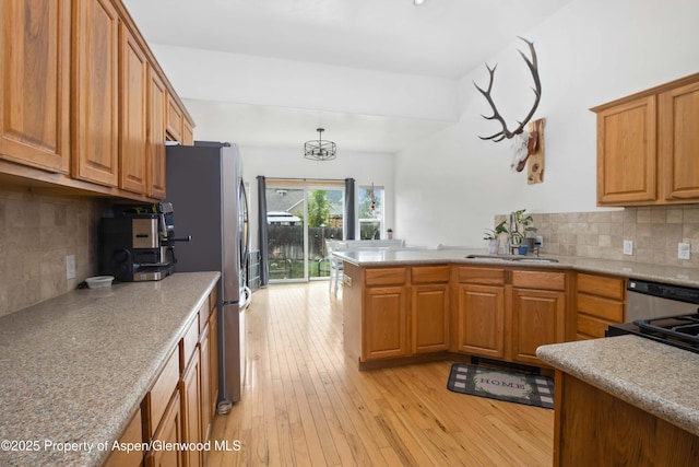 24 Lupine Ln, Parachute, CO 81635 - kitchen featuring freestanding refrigerator, light wood-style floors, backsplash, and brown cabinetry