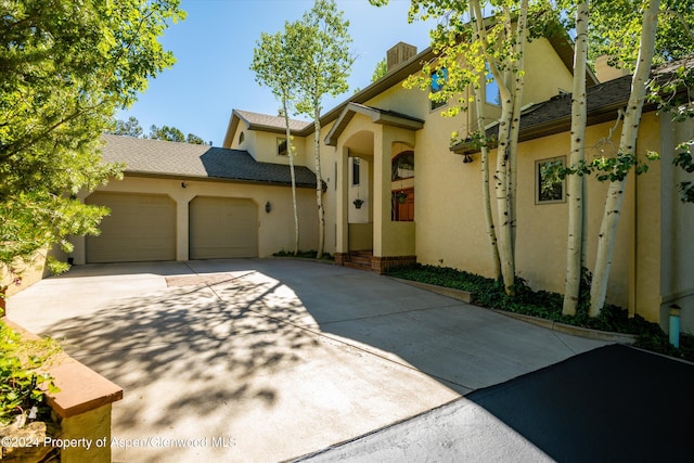 mediterranean / spanish home with a garage