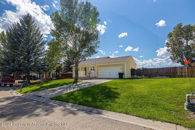 single story home with a garage and a front lawn