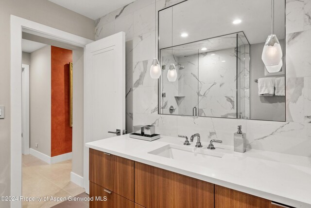 bathroom featuring tile patterned floors, vanity, and walk in shower