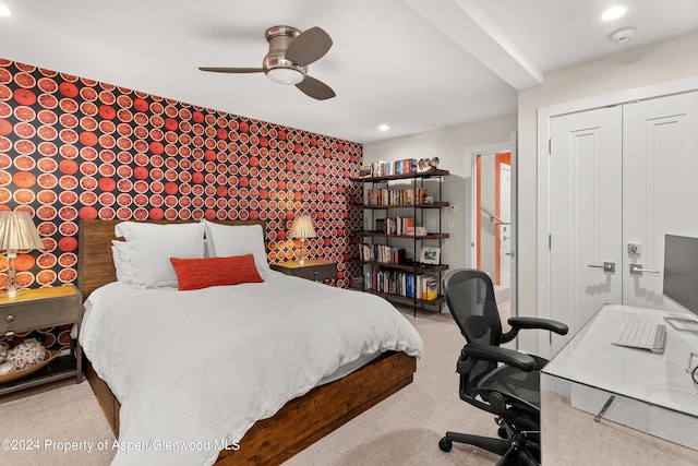 carpeted bedroom with a closet and ceiling fan